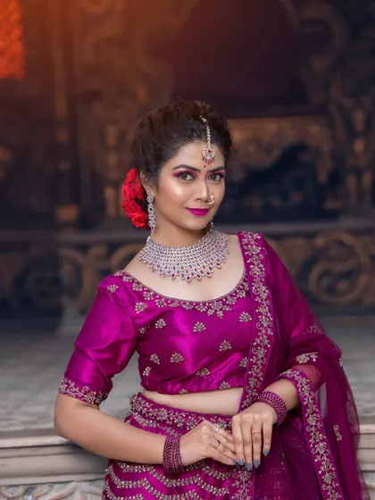 A model in a magenta lehenga, paired with a stunning diamond and ruby choker set.