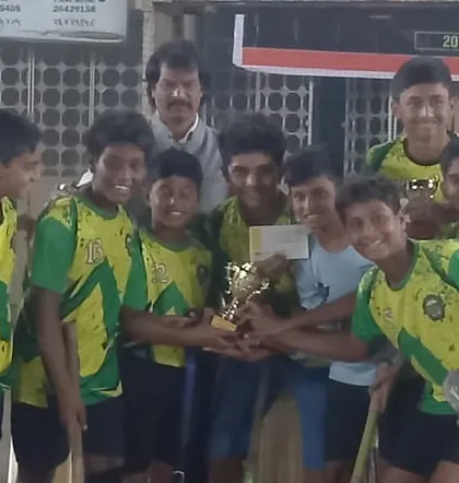 The boys holding their championship trophy high.