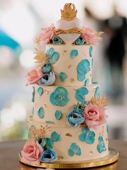 I created this four-tier, all-buttercream Belgian chocolate cake for my cousin's wedding. The unique request was a fondant Sacred Heart topper, which made for a truly personal and meaningful design.