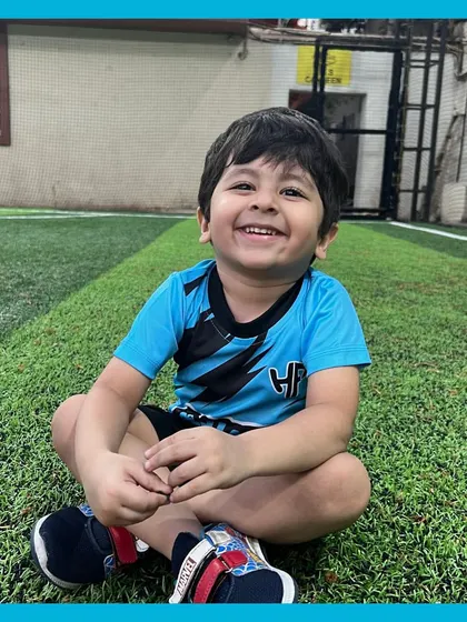 Just look at that smile! This is the result of our 'play, not push' philosophy. We create a positive and fun environment where every child feels happy, confident, and excited to be on the field.