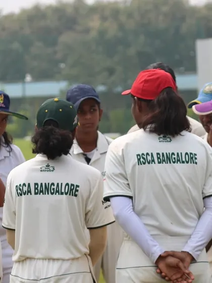 A close-up of the women's team huddle, showing focus and team unity.