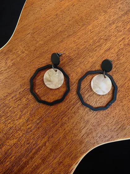 A flat-lay of the western black metal fashion drop earrings, featuring a unique geometric design.