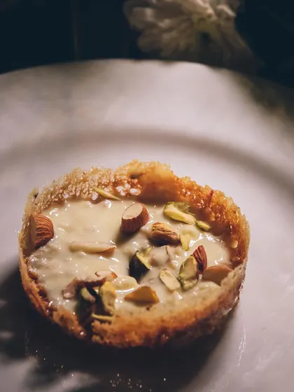 A close-up of our Ghevar tart dessert.