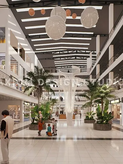 An interior render of another shopping mall concept, featuring a central atrium with a sculptural tree-like element and lush greenery.