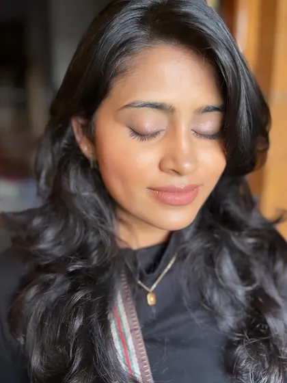 A close-up of the minimal makeup look. The skin is glowing, and the eyes are softly defined.