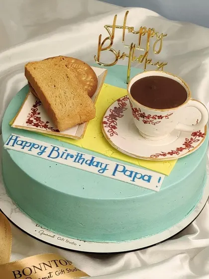 The perfect cake for a dad who loves his morning tea and rusk. This creative design features an edible teacup, saucer, and realistic-looking toast and biscuits.