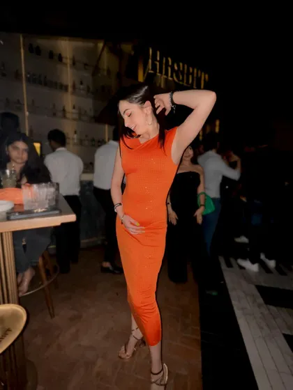 A full-length view of my orange party dress, showing how I style my outfits for a night out.