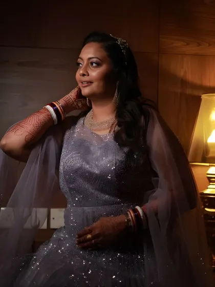 A beautifully lit shot that highlights the soft glam makeup. Even in warm, low lighting, her skin looks radiant and her features are beautifully defined.