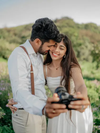 Another take on the selfie pose, this time with a sweet kiss on the cheek. It shows their affectionate and fun-loving relationship.