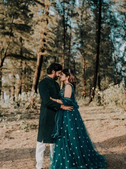 An intimate shot of the couple, highlighting their coordinated outfits in a natural, romantic setting.