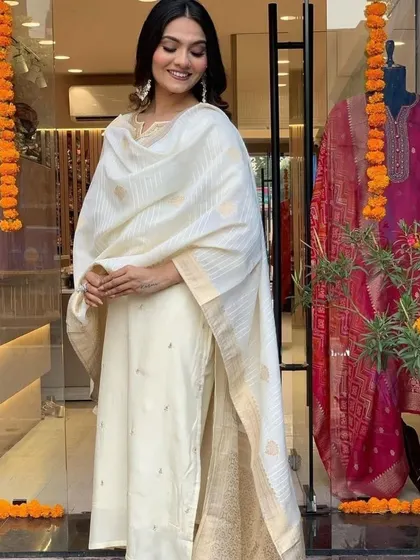 This cream viscose chanderi kurta set is pure elegance. The subtle gold detailing and classic silhouette make it perfect for a puja or family function.