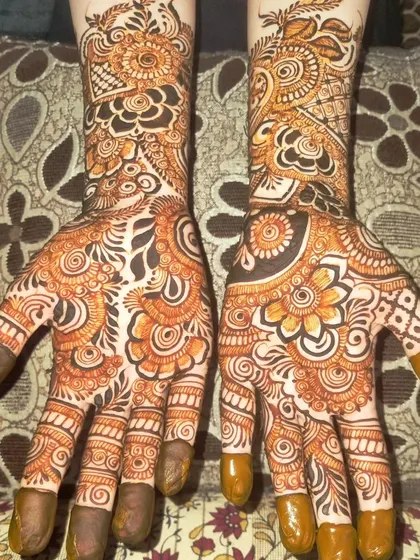 A full-palm view of an intricate design. The palms are filled with a mix of floral mandalas, paisleys, and detailed filler patterns for a very rich look.