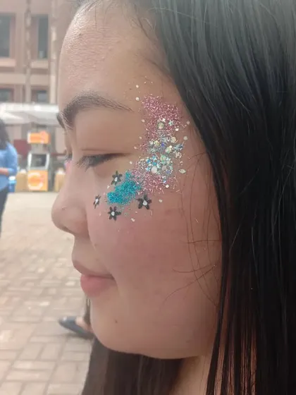 A playful mix of chunky glitter in different colors with small painted stars. This creates a fun, galaxy-inspired look.