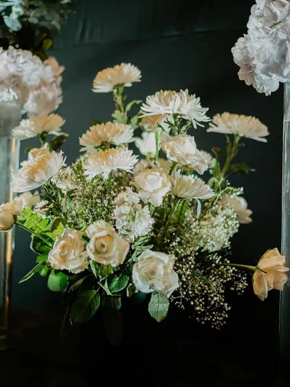 A lush, classic arrangement of white roses, chrysanthemums, and baby's breath. Timeless beauty that elevates any space.