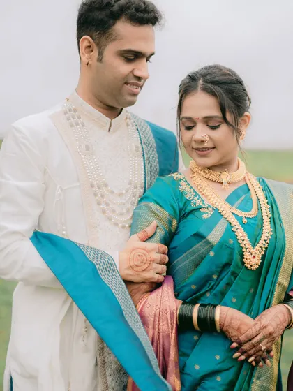 A quiet, intimate moment where the couple is lost in their own world. The groom's gentle touch and their soft expressions make this a very romantic shot.