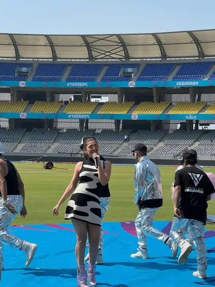 Another shot from the stadium performance, showing how the outfit works in motion and coordinates with the backup dancers.