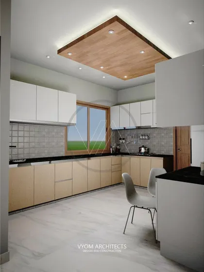 An L-shaped kitchen with a combination of light wood and white cabinets. The design is practical and timeless, with a wooden drop-ceiling feature that adds warmth and defines the space.