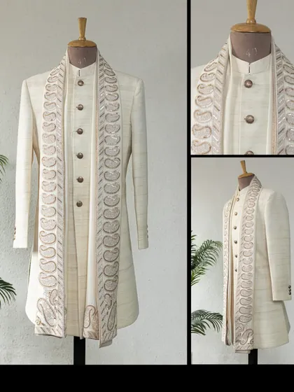 This classic Matka Silk Achkan in ivory, teamed with a paisley dupatta, is a timeless ensemble for any celebration.