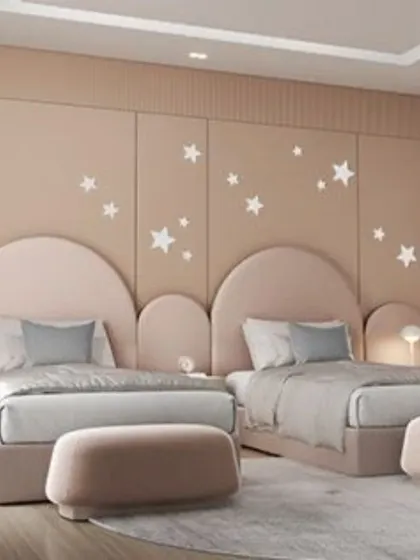 We created a dreamy space with this design, featuring cloud-like headboards and a starry wall decal. The soft pink and neutral tones make this shared room a peaceful and imaginative haven.