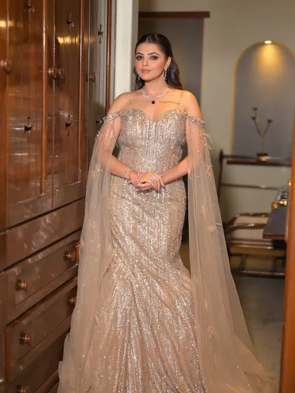 Slaying with a touch of sparkle. This full-length shot showcases how the high-glam makeup and Hollywood waves hairstyle come together with the sequined gown for a truly show-stopping effect.