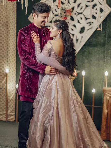 A beautiful pose that showcases the intricate details on the back of the bride's gown while maintaining a romantic connection between the couple.