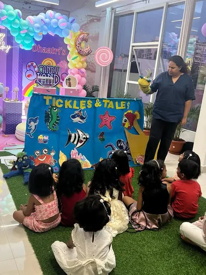 An 'Under the Sea' themed show at a birthday party. The colorful backdrop and puppets, like the crab and seahorse, create an immersive experience for the little ones.