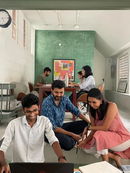 Glimpses of our team at the studio. We foster a collaborative and fun environment where ideas are shared openly, often with our furry studio manager keeping a watchful eye.