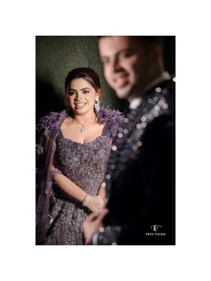 A candid shot of the bride looking towards the groom, her smile radiant, capturing a spontaneous moment of joy during their reception.