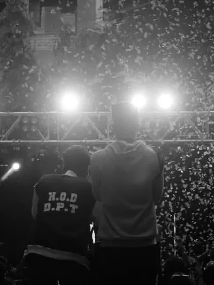 A black and white photo capturing the view from the stage during a confetti drop, showing the scale of the event.