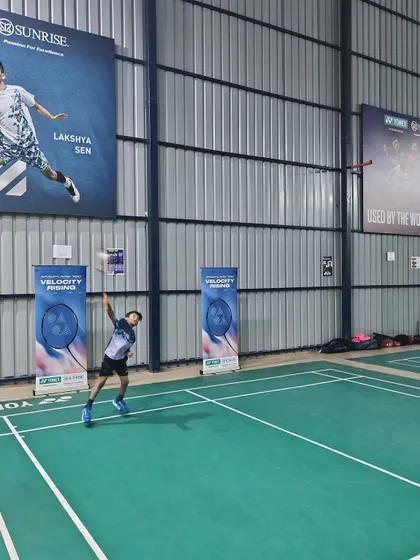 A wide shot of a player executing a powerful smash during the Yonex Demo Day. My spacious, well-lit courts are perfect for hosting such engaging community events.