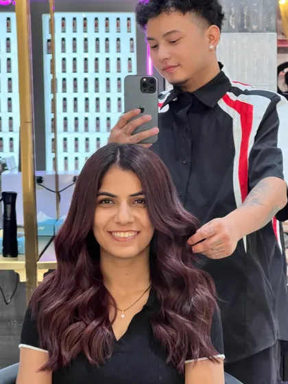 A happy client with her new, rich, mauve-brown color. The shade is unique and flattering, and her smile says it all.