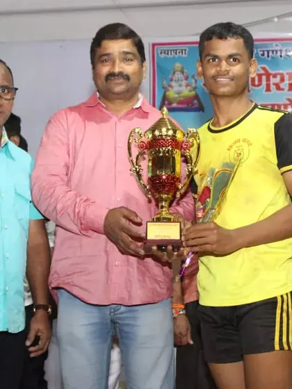 The captain of the sub-junior team receiving the winner's trophy.