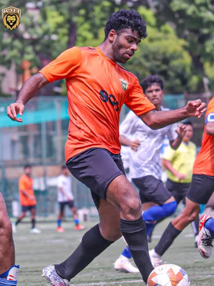 A player focused on the ball, looking to make a play during a competitive match.