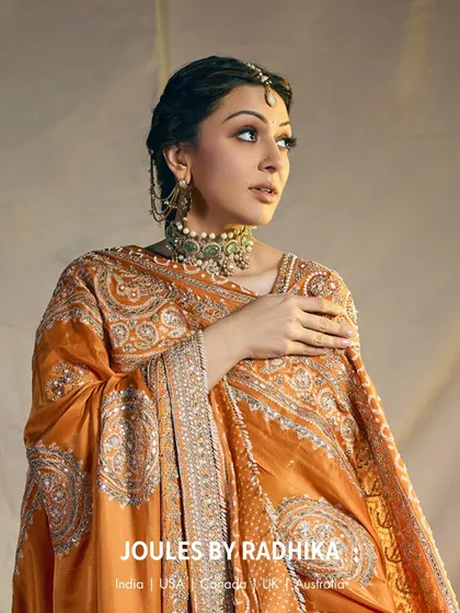 A profile shot of Hansika Motwani, showcasing the intricate details of her earrings and the side view of her choker.