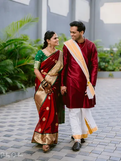 The couple walking hand-in-hand, sharing a smile on their wedding day.