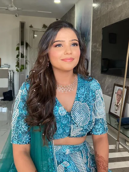 A happy and glowing bride. The combination of dewy skin and a soft glam eye is one of my favorite looks to create, and it looks stunning with her blue outfit.