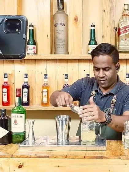 Here I am, live from my bar, demonstrating how to properly use a shaker during a virtual class. The multi-angle setup ensures everyone gets a clear view.