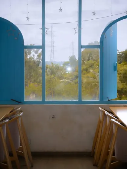 Blue windows in an otherwise muted room. The pop of color and the open shutter create a sense of hope or opportunity.
