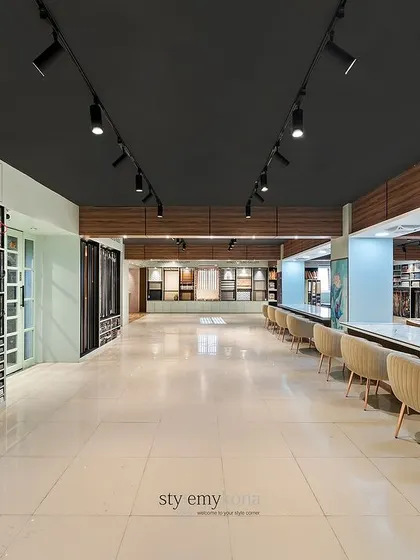 This wide-angle shot captures the scale of the 5,500 sq. ft. showroom. The long sightlines and organized zones for wallpapers, fabrics, and consultation create a seamless and high-end retail experience.