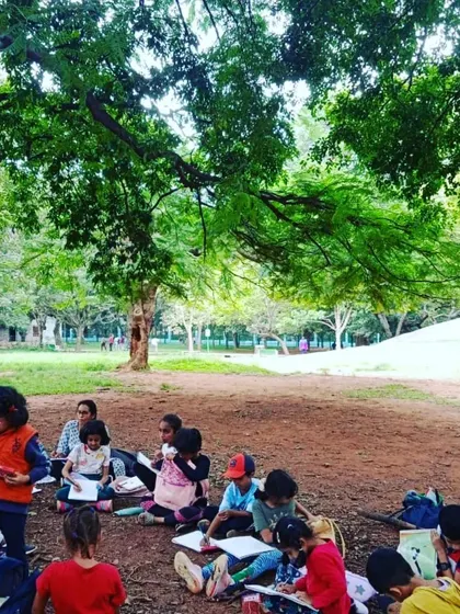 We find a quiet spot under the trees in the park for some nature journaling. These sessions encourage children to slow down, observe closely, and document their surroundings.