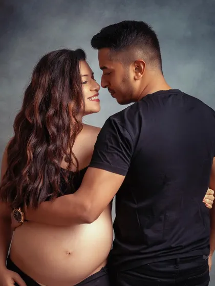 The look of love. This intimate, bare-bump shot against a simple grey backdrop is a powerful and beautiful way to capture your connection.