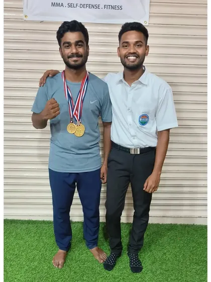 A proud moment between a student and his coach, who also served as a referee at the event. We are involved in every aspect of our students' journey.