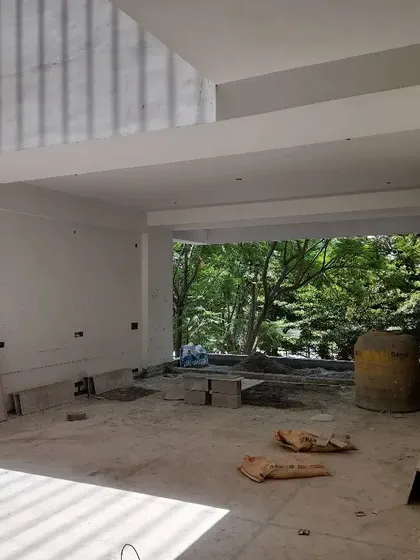 The "Tranquil" project in progress. This space, which will become the first-floor private oasis, is designed to blur the lines between indoors and nature, with a large opening that overlooks the trees.