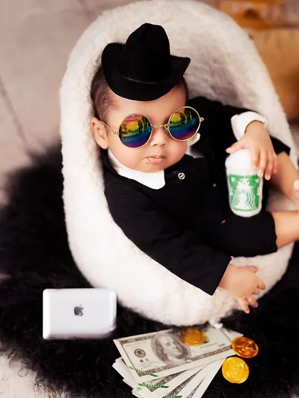 The boss is in! This little guy is ready for his morning coffee and a day of big deals, complete with cool shades and an iPhone prop.