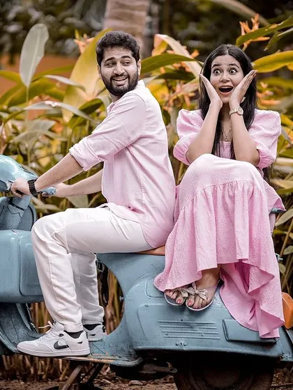 A playful and surprised expression from the couple on a retro scooter, making for a fun and memorable candid-style pre-wedding shot.