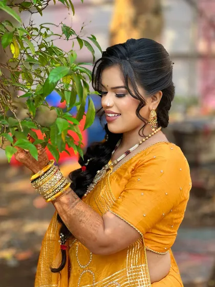 A candid moment of the bride, her smile as bright as her outfit.