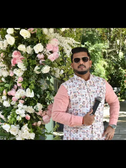 A confident pose amidst the floral decor of a Haldi.