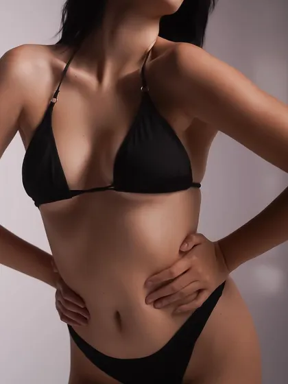 This is a clean e-commerce style shot for a classic black bikini. The focus is entirely on the product's fit, cut, and form, using soft, even lighting to show the details clearly.
