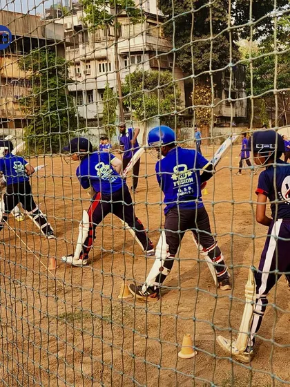 A closer look at our players during net practice. Dressed in full gear, they work on their batting stance and technique, demonstrating the serious and disciplined approach we foster.
