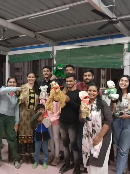 A group of volunteers from a corporate team learning the basics of puppetry. These workshops are designed to be fun and experiential, giving them skills they can use in their outreach work.